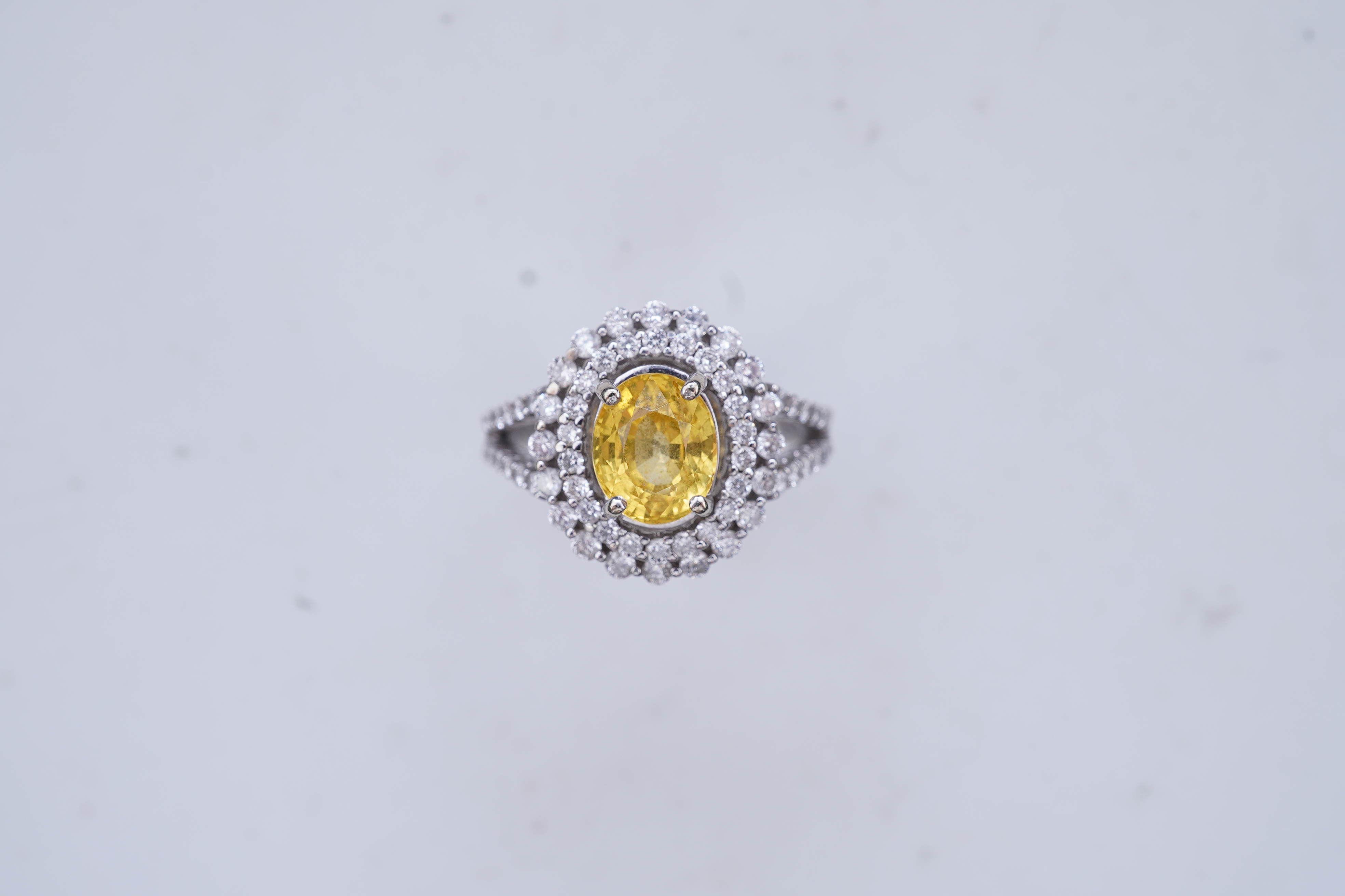 A yellow sapphire and diamond ring